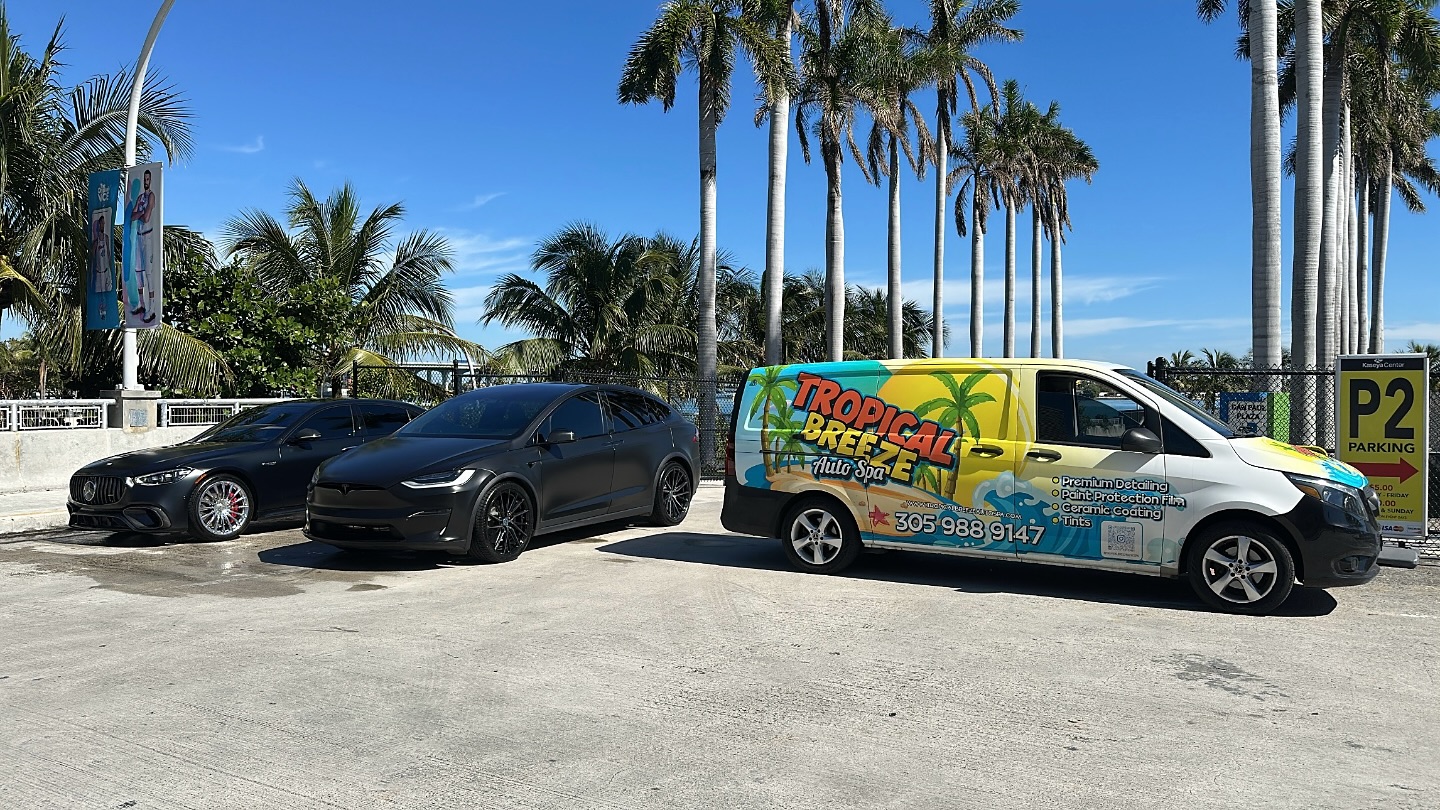 Mercedes AMG and Tesla Model X beside Tropical Breeze service van