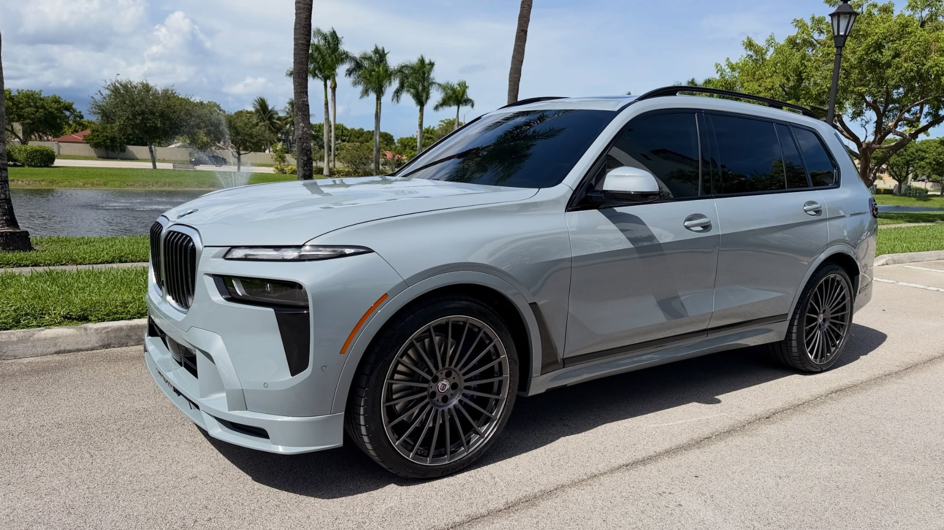 Ceramic coated BMW beside a South Florida lake and palm trees