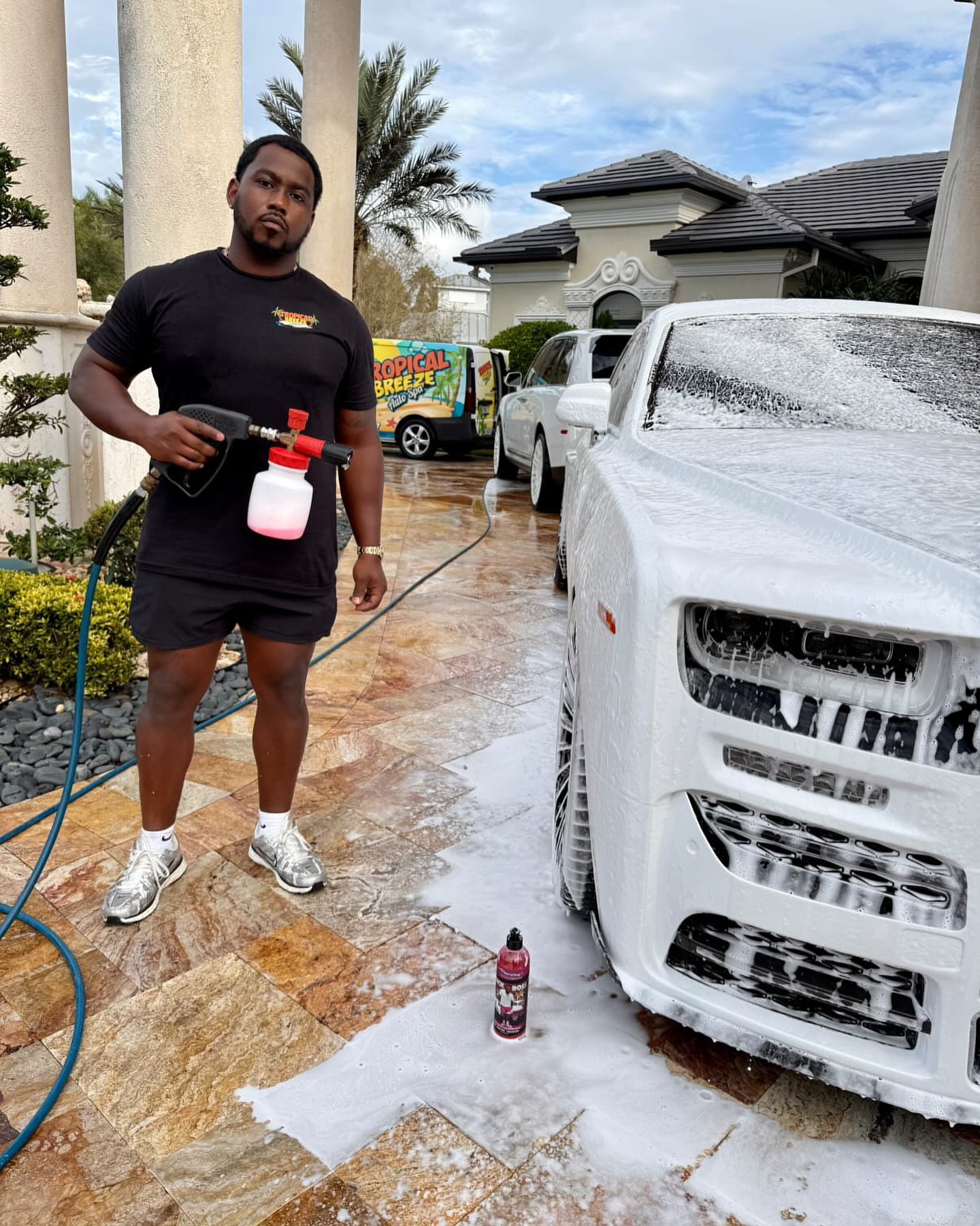 Tropical Breeze detailer preparing a white Rolls-Royce Ghost